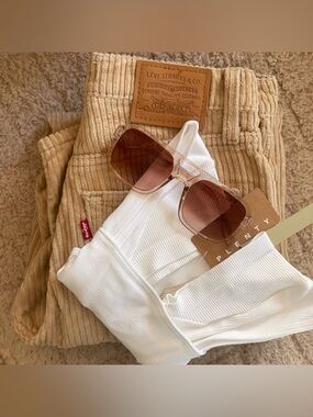Levi's Corduroy Pants and white bodysuit and sunglasses.